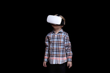 Little blond boy with glasses of virtual reality. Plaid shirt. Black background