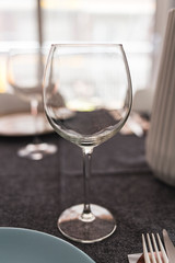 Empty wineglass on a served meal table