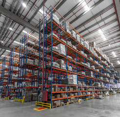 logistic shed and distribution boxes workers and forklift in operation