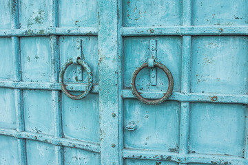 blue vintage metal door with round knobs