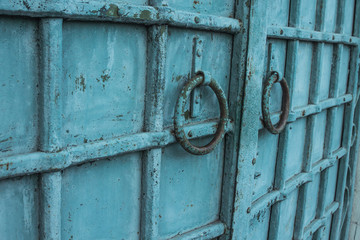 blue vintage metal door with round knobs