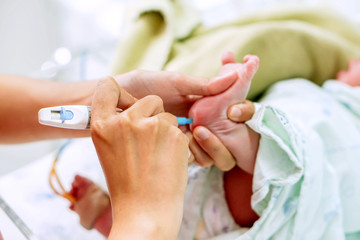Hands of pediatric nurse holding and using Accu-Chek Fastclix (needle pen for blood and glucose...