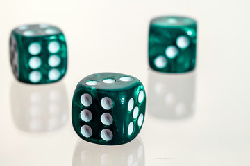 Three green casino dice with white background