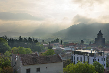 Mtskheta - ancient capital of Georgia. Top view of old town with Svetitshoveli Cathedral in morning backlit