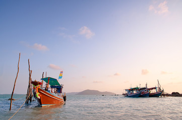 Fototapeta premium Traveling by Thailand. Ocean, beach and old fishing boat.