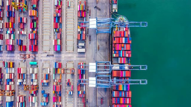 4k, Hyper lapse aerial view container ship loading and unloading in deep sea port, Aerial top view of logistic import export transportation business by container ship in open sea.