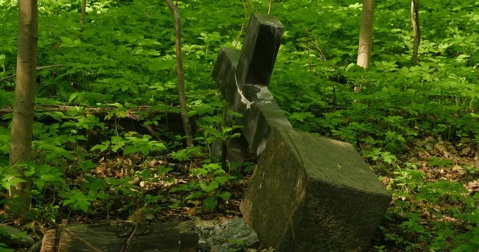 fallen grave cross in the old cemetery