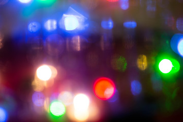 Blurred colored lights. Bright round multi-colored spots, background and pattern for design. Texture of colorful lanterns in the background.