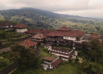 Fototapeta na wymiar Aerial view of abandoned hotel buildings in tropical mountains