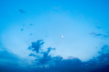 Fototapeta na wymiar dark blue evening sky. The young moon is high. Beautiful clouds