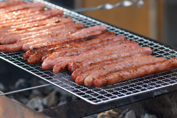 Pork meat sausages cooking on grill