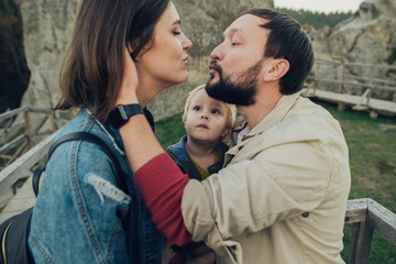 Naklejka premium Happy family: mother father and child in mountains. 