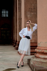 Fashion look's woman. Young woman modern portrait. Young woman dressed in white skirt and shirt...