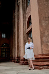 Fashion look's woman. Young woman modern portrait. Young woman dressed in white skirt and shirt...