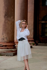 Fashion look's woman. Young woman modern portrait. Young woman dressed in white skirt and shirt...