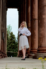 Fashion look's woman. Young woman modern portrait. Young woman dressed in white skirt and shirt...