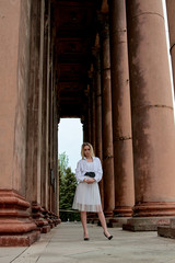 Fashion look's woman. Young woman modern portrait. Young woman dressed in white skirt and shirt...