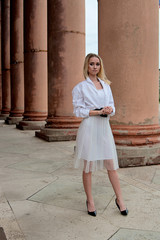 Fashion look's woman. Young woman modern portrait. Young woman dressed in white skirt and shirt...