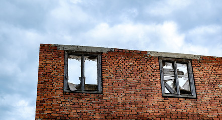 the walls of an abandoned house on cloudy sky