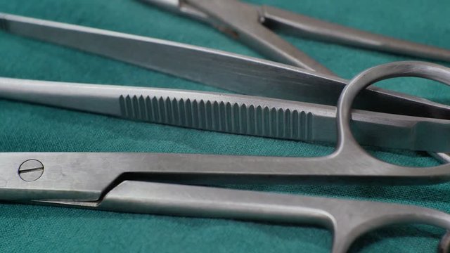  Close up surgical equipment on green background.