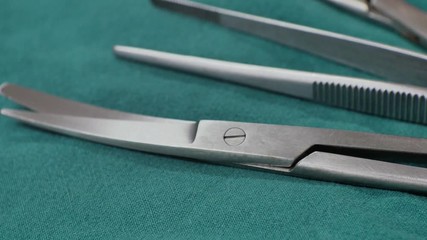  Close up surgical equipment on green background.