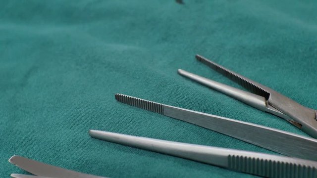  Close up surgical equipment on green background.