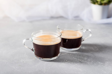 Two Cups of coffee on grey background