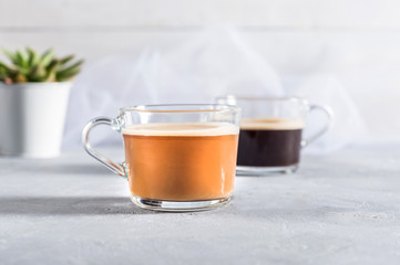 Two Cups of coffee on grey background