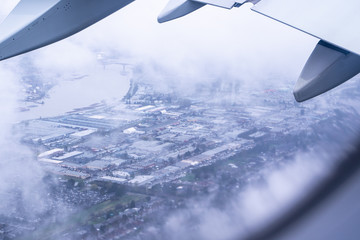 View Out Plane Window Over Cloudy City