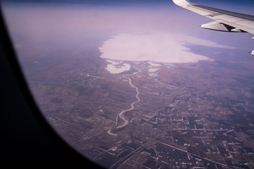 Fototapeta na wymiar View From Plane Over City, River, and Large Lake