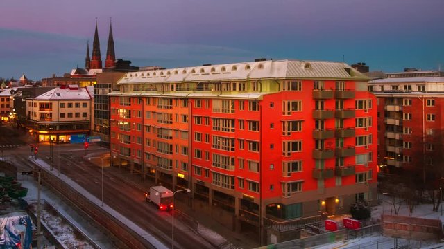 Uppsala, Sweden. Aerial view of historical buildings in Uppsala, Sweden at sunrise. Time-lapse from night to day with car traffic and colorful sky