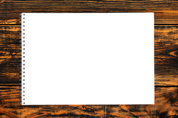 Blank paper on the wooden background. Top view.