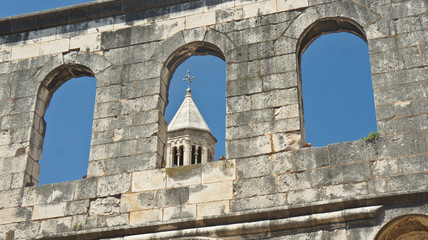 View of the church tower through the windows in the street of old town, Diocletian palace beautiful architecture, sunny day, Split, Dalmatia, Croatia
