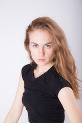 studio portrait of a slim young woman in black clothes