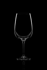 Empty clear wine glass over black background