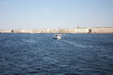 a view of the river, boat and buildings