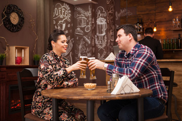 Couple in love on date drinking beer and having a good time.