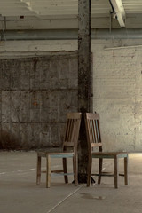 Fototapeta na wymiar Two Antique Chairs Against A Wooden Beam