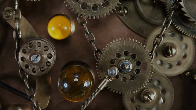 Steampunk, a time machine with rotating gears, a chain, blinking lights, springs. Very similar to a clock mechanism or a working device in the old style.