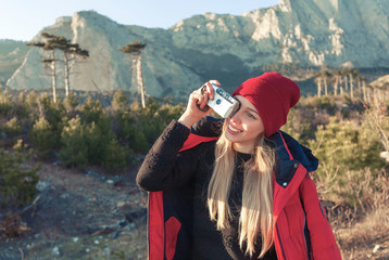 Young woman taking photo during hiking trip