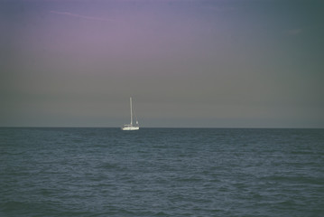Fototapeta premium Yacht in the sea against the sunrise sky early morning