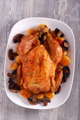 Roast chicken with potatoes and mushrooms