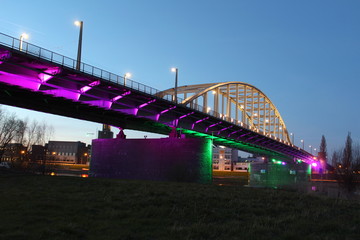 John Frost Bridge in Arnhem during blue hour while colorful lights shine on the bridge