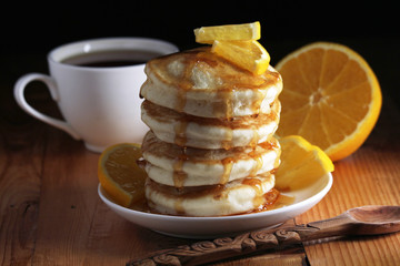 A stack of freshly backed pancakes and a cup of coffee