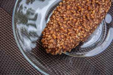 Tasty chocolate cake with nuts on a saucer. Top view