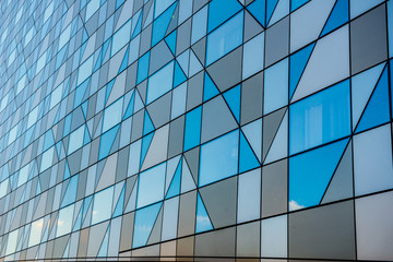 Fototapeta na wymiar Grey faceted facade of a building.