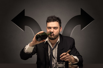 Drunk disappointed man sitting at table with arrows around
