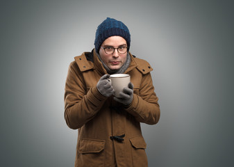 Handsome young boy freezing in warm clothing with copy space