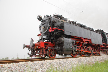 Fototapeta na wymiar Retro vintage steam locomotive on rail tracks