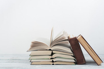 Open book, hardback colorful books on wooden table. Back to school. Copy space for text. Education business concept.